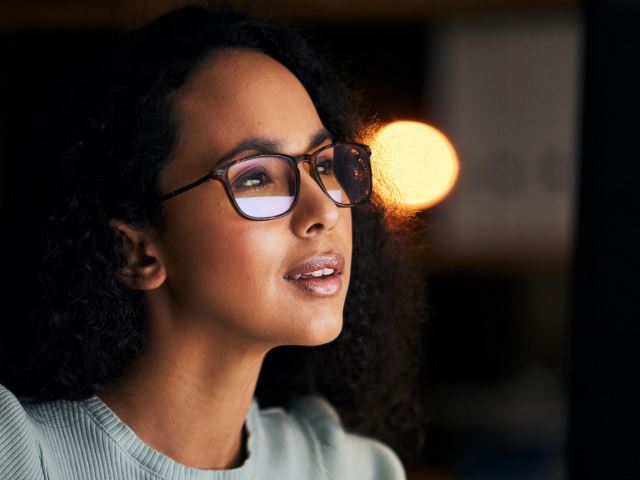 Professional woman wearing glasses with an inspired expression