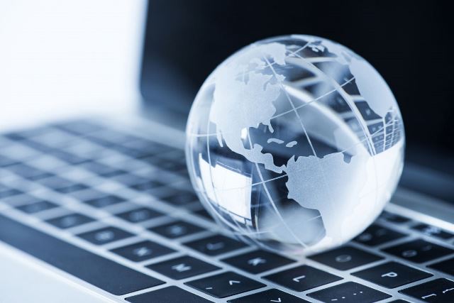 Glass globe sitting on laptop keyboard