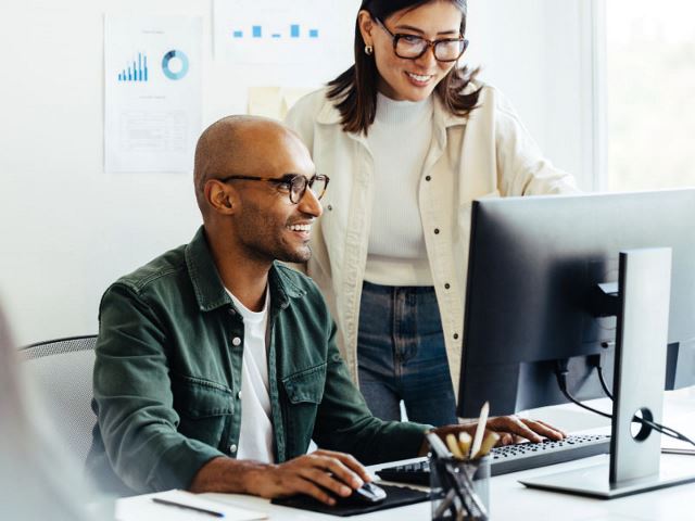 Colleagues working together at a computer