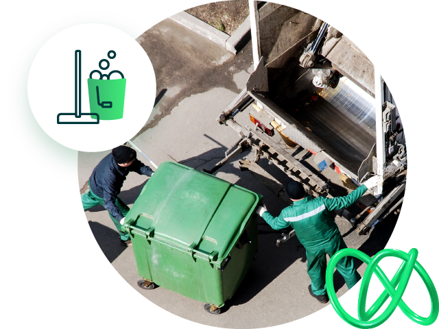 Sanitation workers emptying a dumpster