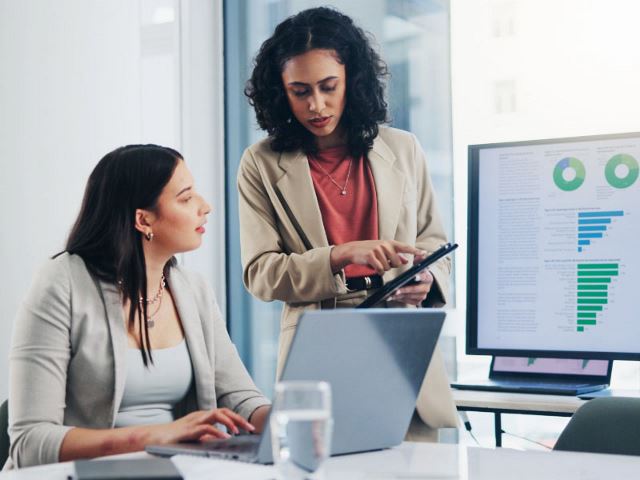 Two colleagues looking at graphs together