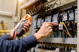 Electrician's hands using a voltmeter