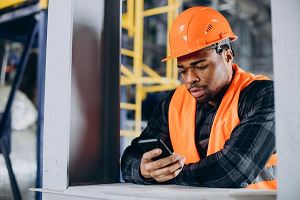 Man using phone with hardhat