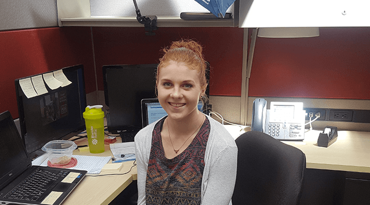 Billtrust Intern sitting at desk in office