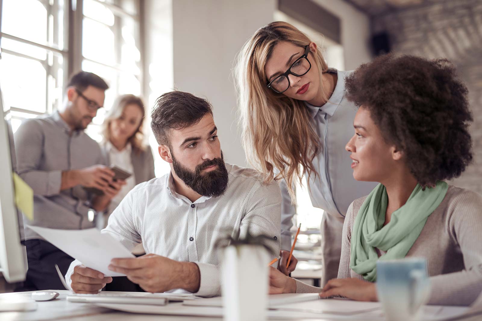 employees looking at a sheet of paper