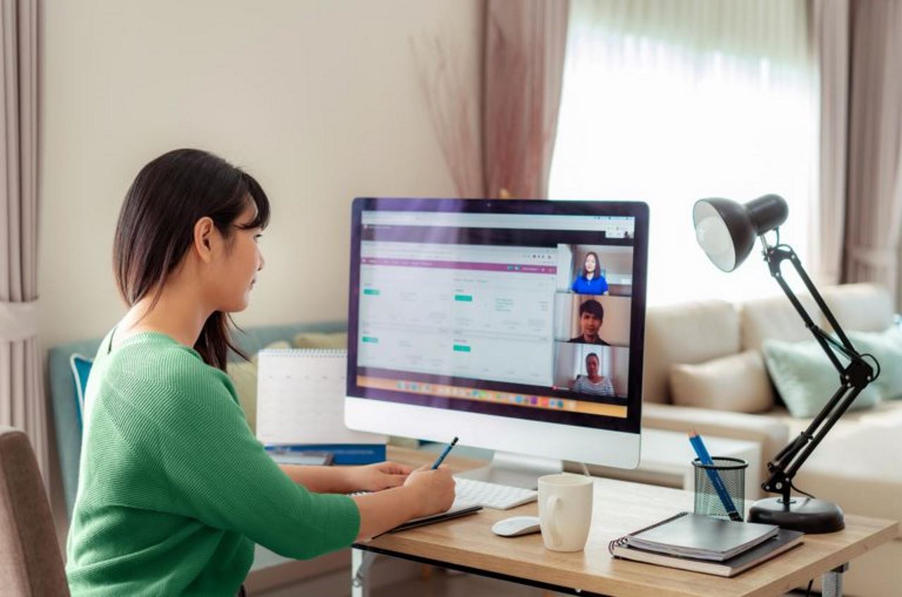 Female employee on zoom call with coworkers