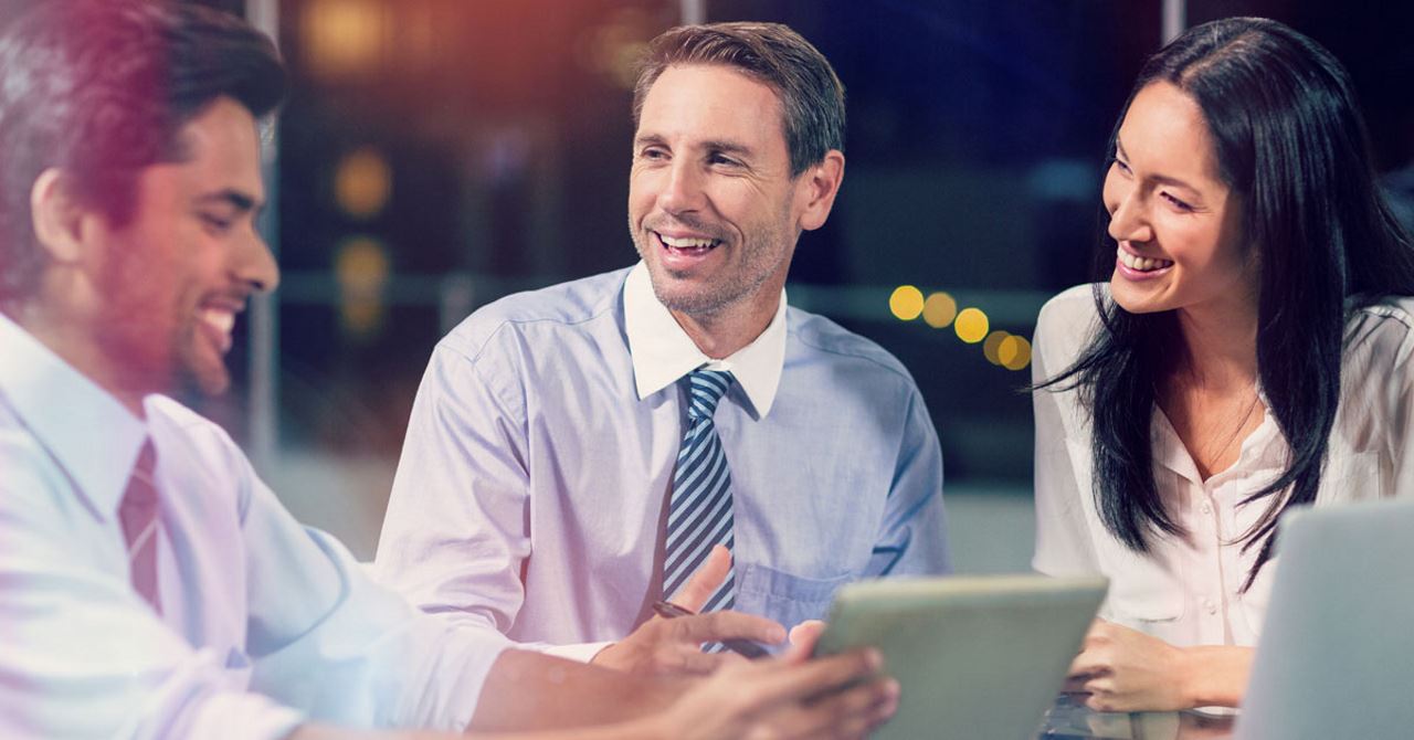 two men and one woman laughing and having a conversation