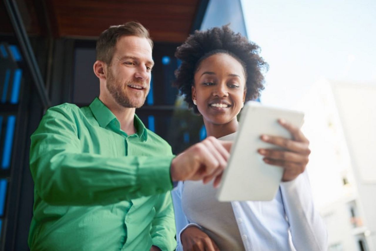 employees looking at a tablet