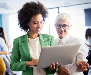 Two female colleagues looking at computer