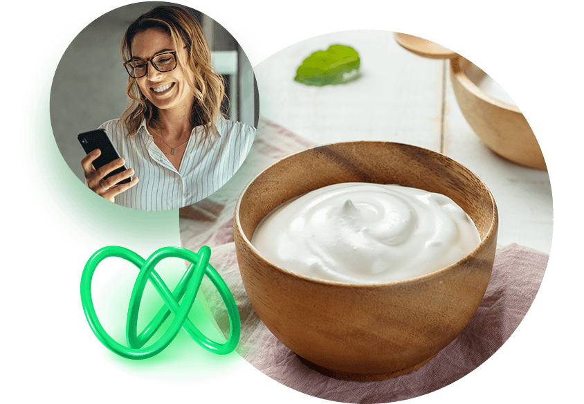 Bowl of yogurt with woman looking at phone